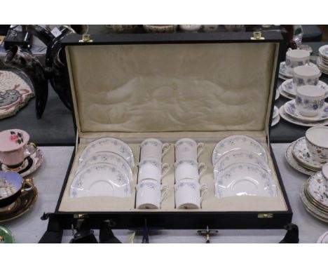 A SET OF ROYAL DOULTON 'ANGELIQUE' COFFEE CANS AND SAUCERS IN A PRESENTATION BOX