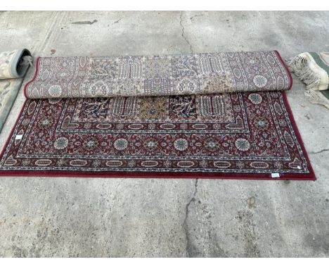 A VINTAGE STYLE RED PATTERNED RUG