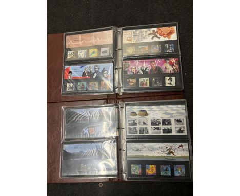TWO FOLDERS CONTAINING A LARGE QUANITY OF FIRST DAY COVERS