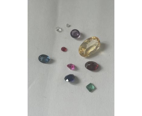 A QUANTITY OF GEMSTONES TO INCLUDE CITRINE, AMETHYST, SAPPHIRE, EMERALD, GARNET, RUBY ETC TOTAL WEIGHT 7.1 CARAT. THE VENDOR 