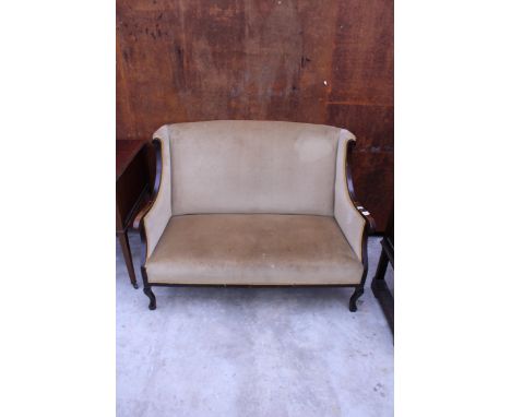 AN EDWARDIAN BEECH FRAMED TWO SEATER SOFA