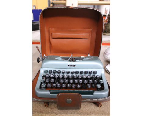 A VINTAGE IMPERIAL TYPEWRITER, CASED WITH ORIGINAL PAPERWORK AND CLEANING TOOL