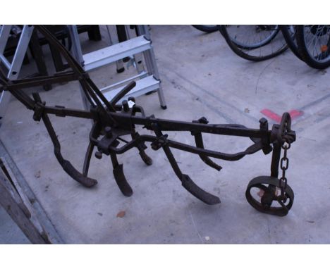A VINTAGE CAST IRON FIVE LEG HORSE DRAWN CULTIVATOR