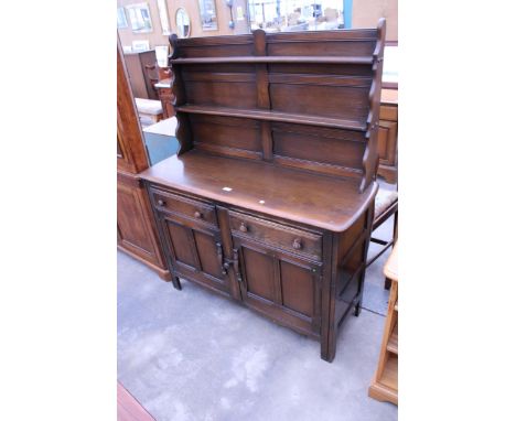 AN ERCOL ELM DRESSER WITH PLATE RACK, TWO CUPBOARDS AND TWO DRAWERS TO BASE, 48" WIDE