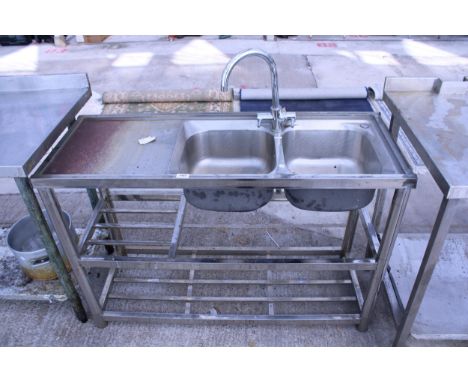 A STAINLESS STEEL KITCHEN SINK UNIT WITH LOWER SHLEVING