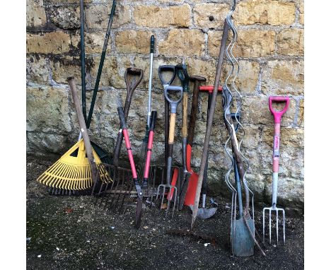 A quantity of vintage garden tools to include forks, rakes, spades, etc 