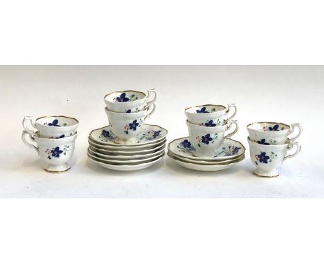 A set of eight hand painted floral teacups and saucers, heightened in gilt 