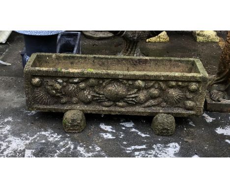 A rectangular composite stone planter with crab and shell detail, 89x23x31cmH including feet 