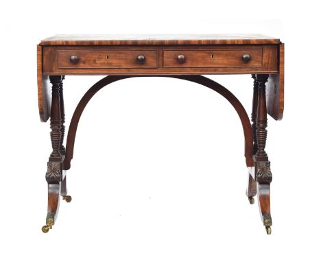 A Regency mahogany sofa table, two frieze drawers with opposing blind drawers, on four turned supports and high arched stretc