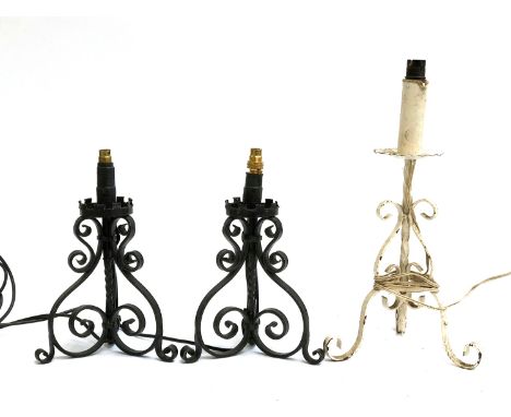 A pair of black painted wrought iron table lamps, 31cmH; together with a taller similar white painted table lamp, 44cmH (2) 