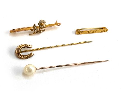 A 9ct gold brooch set with a citrine and seed pearl flower, 4cmW; together with a 9ct gold 'Baby' brooch and two stick pins, 