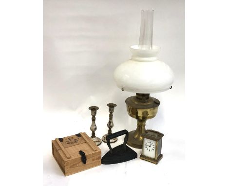 METAL WARES: an oil lamp with chimney and shade together with a French carriage clock (a/f) and a heavy old iron and other it
