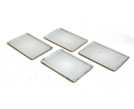 A set of four early 20th century small enamel trays with gilt rim, each 22.5x15cm 