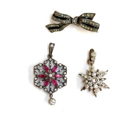An early 20th century 900 silver and paste lavalier pendant, 2.2cmW; together with a gilt metal and paste star pendant and an