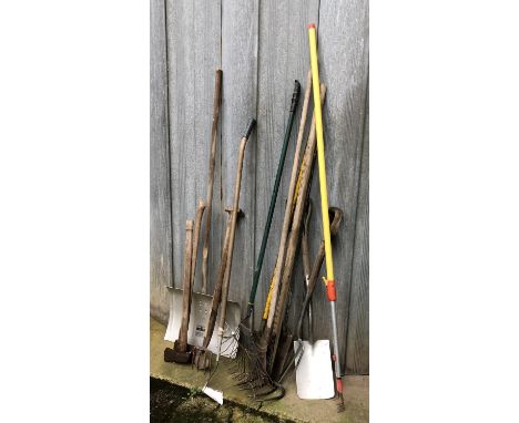 A quantity of vintage garden tools to include rakes, snow shovel, spades, axes, etc 