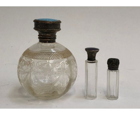 Three silver topped glass scent bottles, two with guilloche enamel lids, the tallest 12cmH 