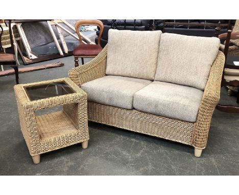 A wicker conservatory sofa, 140cmW, together with a glass topped wicker occasional table 