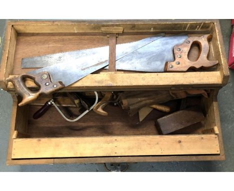 A carpenter's toolbox containing a quantity of vintage tools to include planes, saws, etc 