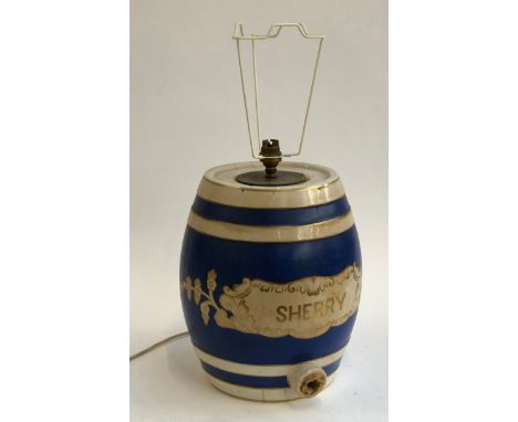 A ceramic sherry barrel, converted as a lamp, 31cm high; together with two further table lamps 