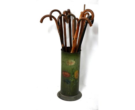 A Victorian toleware stick stand with sticks 