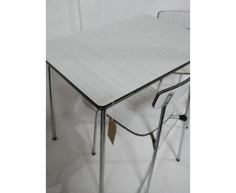 A vintage formica table and two chairs by Tavo 