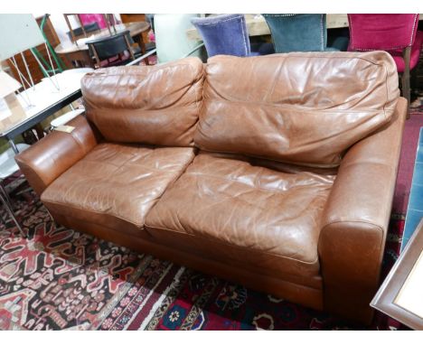 A tan leather two seat sofa 