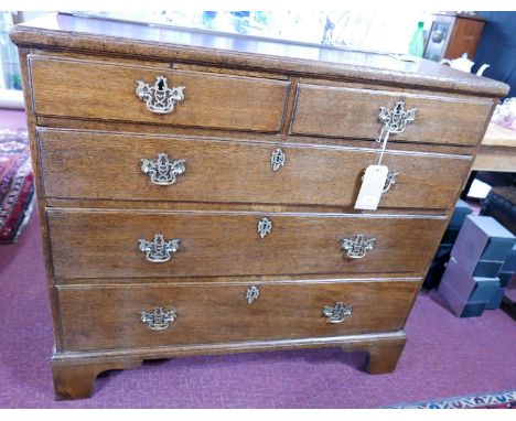 An early Georgian oak chest, two short over three long, raised on bracket feet, H.100 W.109 D.52cm 