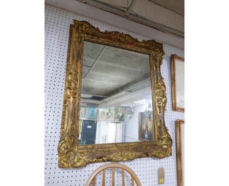 A 20th Century ornate gilt wood mirror. 100cm x 82cm 