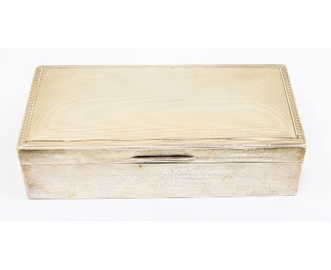 An Elizabeth II silver engine turned cigarette case, plain body engraved with presentation inscription dated (19)62, hallmark