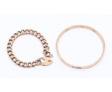 A 9ct gold slave bangle and 9ct gold hollow link curb bracelet with padlock clasp, combined total weight approx 26.4gms Condi