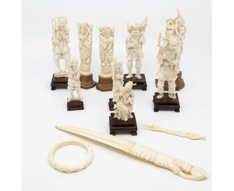 Nine carved ivory okimonos, carved ivory paper knife; bangle; etc