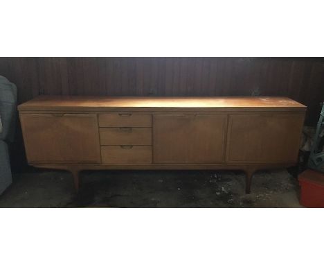 SCANDINAVIAN DESIGN:A large teak sideboard with a length of 220 cms (7'2") the legs set in just over 1 foot from the outside 