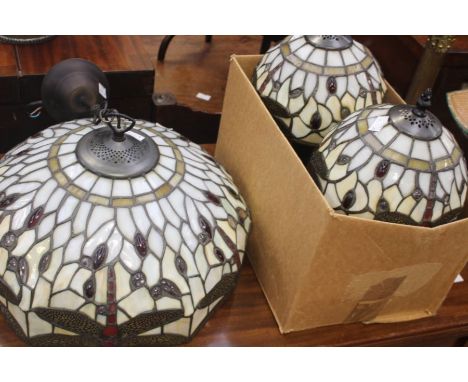 A collection of lighting to include a Tiffany style ceiling light, with two matching side table lamps, in the same design, an