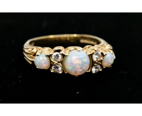 A Victorian style 18ct gold three stone opal ring accented with four brilliant cut diamonds, size N, total gross weight 3.75 