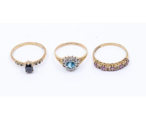 Three 9ct gold rings including a blue topaz and cubic zirconia ring size M, a sapphire and diamond dress ring, size N and a p