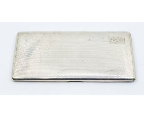 A George VI engine turned large silver rectangular cigarette case, engraved initials to cover, hallmarked Birmingham, 1941, 9