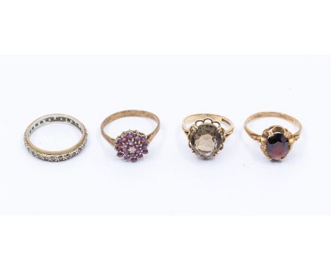 Two smoky quartz and 9ct gold dress rings, with oval cut stones, sizes K, Q, a 9ct ruby set cluster, size R1/2, and a silver 