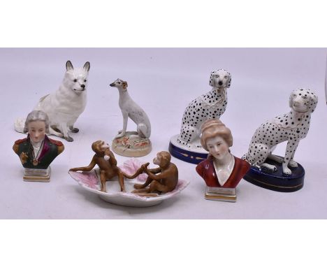 A Staffordshire Dalmatian, seated with chain lead, on an oval base; another, similar; a Staffordshire style greyhouse, seated