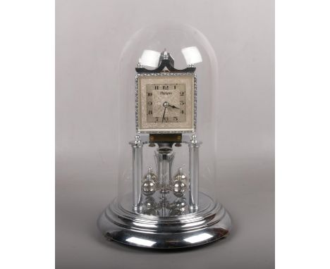 A German chrome plated torsion clock under glass dome. With square silvered dial signed Olympia. Works stamped Euramca, 30cm.