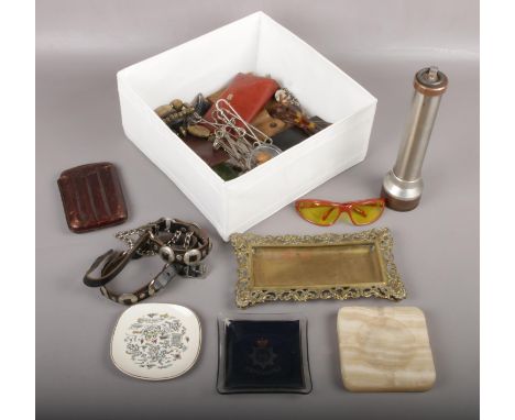 A box of collectables to include flash light, metal trinket dish, sunglasses, leather collars etc.  