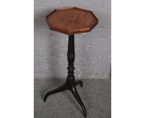 An octagonal tripod table with marquetry top.  