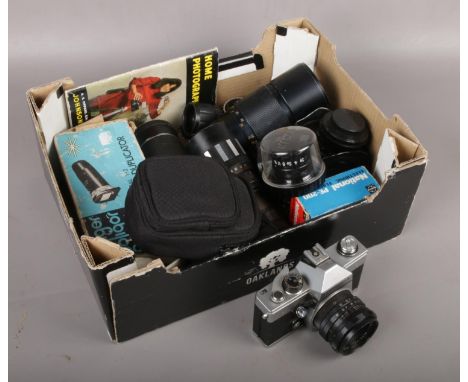 A box of camera equipment to include Praktica camera, lenses etc.  