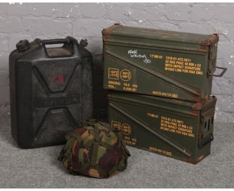 Two ammunition crates, a camouflaged 1985 Nato helmet and a plastic water carrier in the form of a jerry can.  