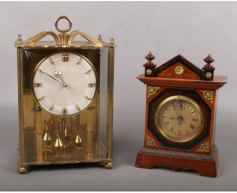 A brass cased Koma anniversary clock along with another German clock incorporating subsidiary seconds.  