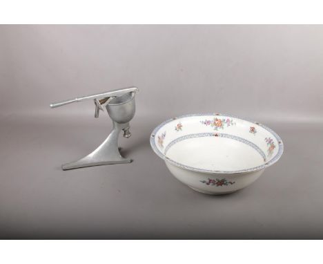 A large ceramic Bowl and fruit press.  