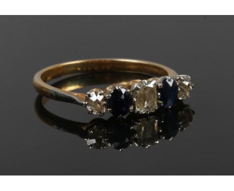 An antique gold diamond and sapphire ring with central cushion cut diamond, Size N 1/2, 2.55g.  