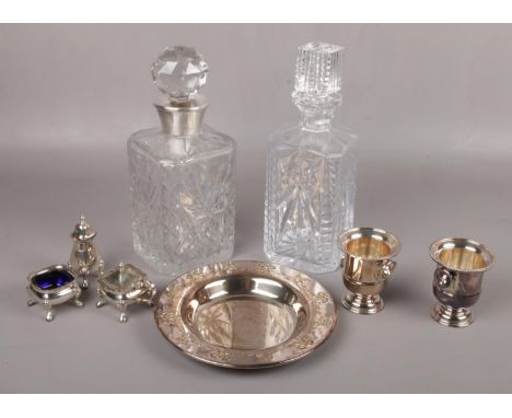 A cut glass decanter with silver collar, another decanter and a quantity of silver plate including a Harewood three part crue