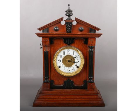 An oak cased 8 day automatic alarm clock by Fattorini &amp; Sons. Bradford. With ebonized mouldings and ting tang strike, 46c