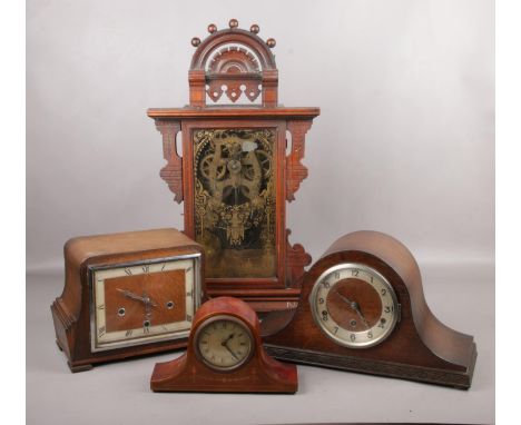 A Seth Thomas gingerbread clock, along with three mantle clocks.  Gingerbread clock in need of repair.