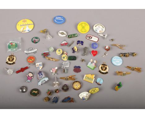 A collection of badges, Pond Hopper Club 2000, National Blood service, Girl Guides examples  